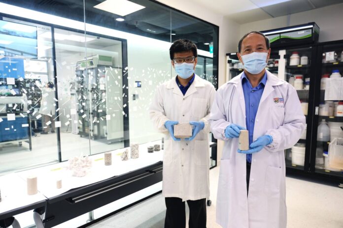 Using only waste as raw materials, NTU scientists have found a way to create biocement, making the alternative to regular cement even greener and more sustainable. This biocement is already being used in trials to strengthen the sand on Singapore’s shorelines and to restore rock carvings in China. The NTU scientists used two common waste materials, industrial carbide sludge and urea—from the urine of mammals—to create this renewable form of cement. When bacteria is added into the mix, and the resulting solution sprayed onto soil or sand, a hardening reaction takes place that binds the soil particles into a solid block. The researchers say their biocement can potentially become a sustainable and cost-effective method for soil improvement, reducing dust or wind erosion in the desert, or building freshwater reservoirs on beaches or in the desert. A big advantage of the NTU team’s method in formulating biocement is the solution is colourless. When applied to soil, sand or rock, their original colour is preserved. This makes it useful for restoring old rock monuments and artifacts. The biocement has been used to restore broken-off pieces, such as the fingers of a Buddha’s hands from the Dazu Rock Carvings, a UNESCO World Heritage Site in China. The biocement-making process requires less energy and generates fewer carbon emissions compared to traditional cement production methods. Biocement is produced at room temperature without burning anything, and is thus a greener, less energy demanding, and carbon-neutral process. https://www.ntu.edu.sg/